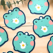 Load image into Gallery viewer, Cute Frog w/ Fried Egg Vinyl Sticker by Fat Rabbit Farm