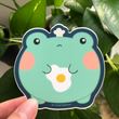 Load image into Gallery viewer, Cute Frog w/ Fried Egg Vinyl Sticker by Fat Rabbit Farm